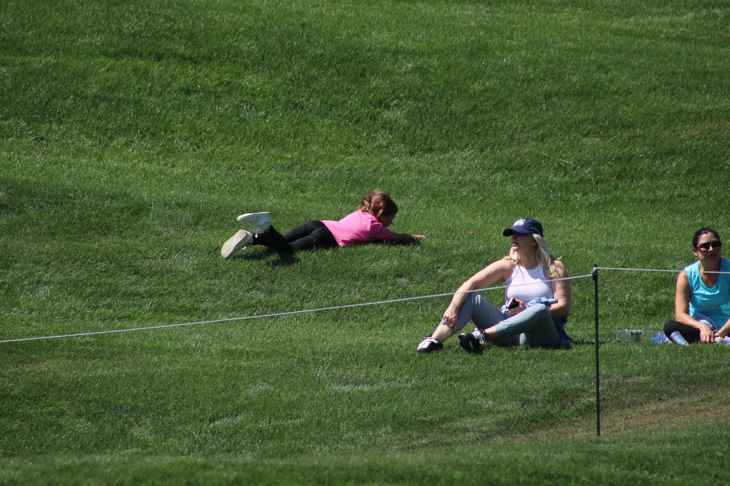 Children rolling down a hill is a popular pastime at THE PLAYERS.